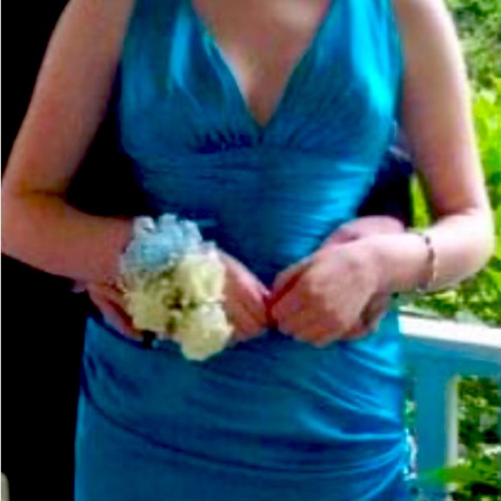 Teal open back prom dress with blue and green stones on right side